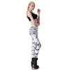 Model wearing black halter top and white leggings with black tiger stripes, side view